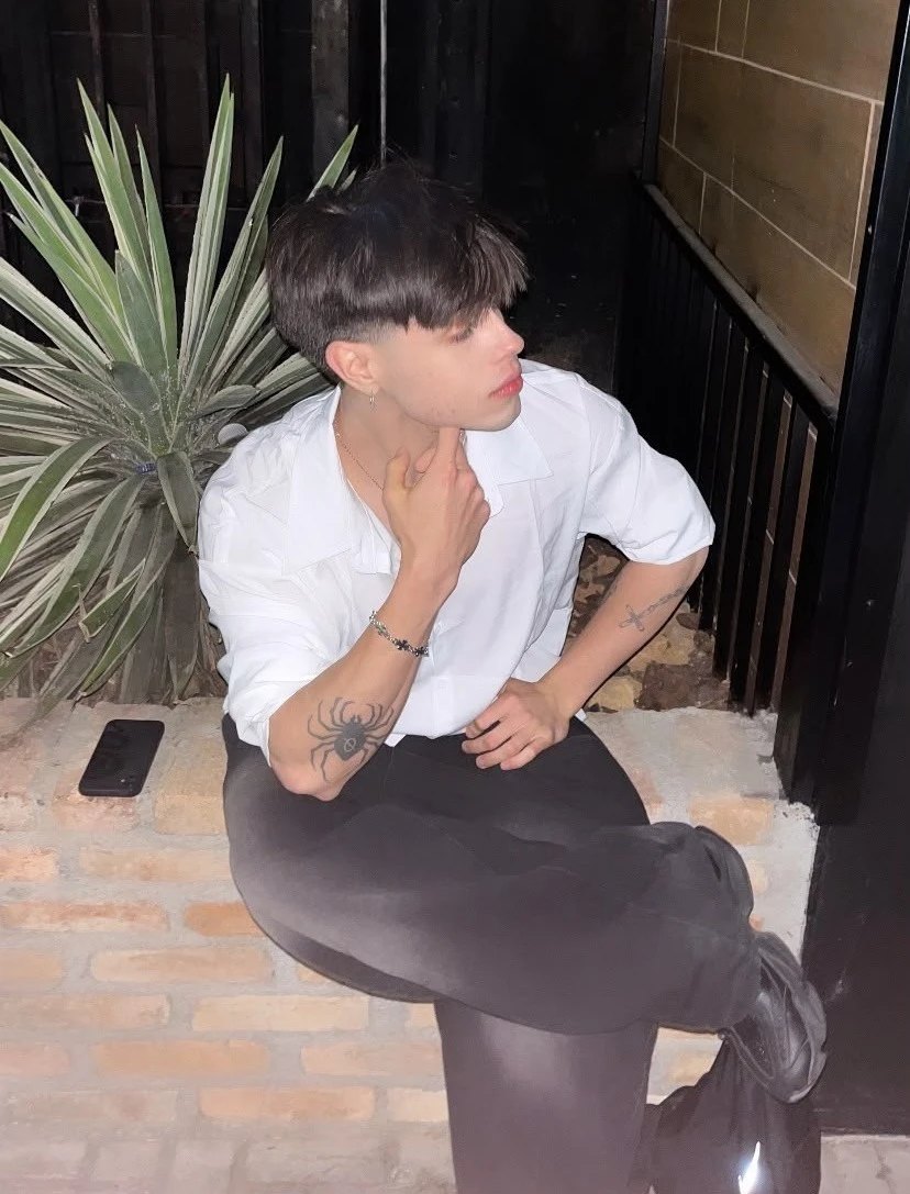 Lucas Melo in a white shirt, at night